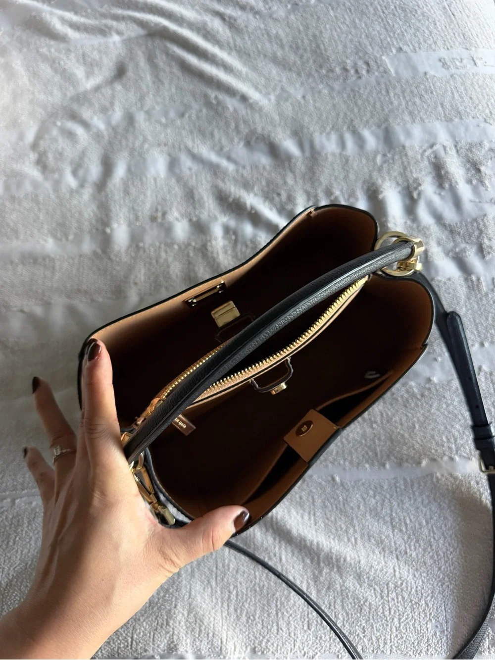 Kate Spade Phoebe black refined grain leather satchel with gold-tone hardware.